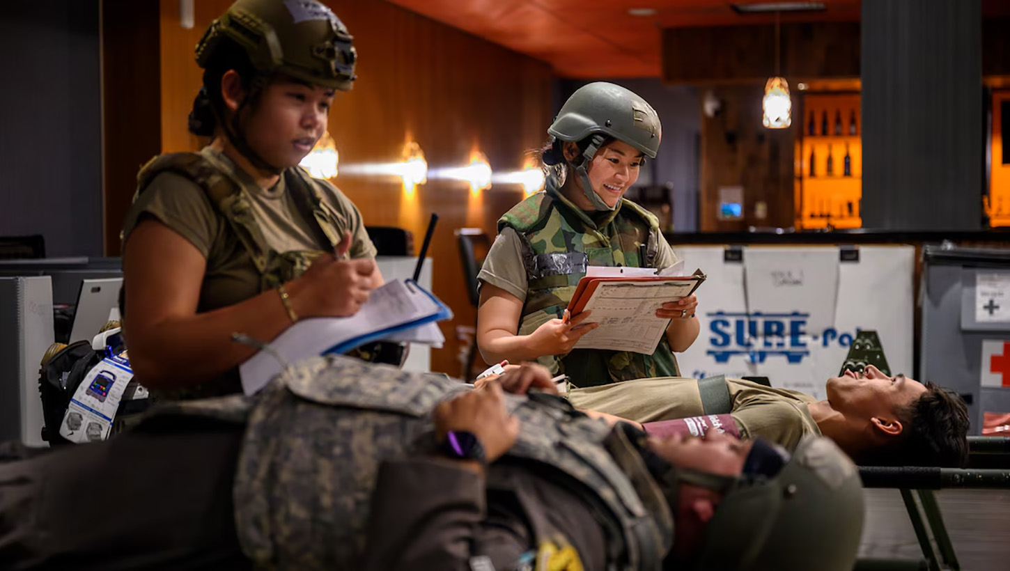 U.S. Air Force Capt. Saidel Sunga, left, and Capt. Manami Jones, 18th Medical Group clinical nurses, monitor simulated patients inside an En-Route Patient Staging System facility before aeromedical evacuation during Beverly Beach 26-1