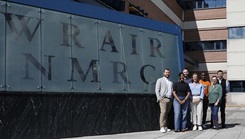 Staff with Naval Medical Research Command (NMRC) and Walter Reed Army Institute of Research (WRAIR) pose for a group photo outside the Robert K. Inouye building at Forest Glen Annex.