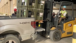 Staff members at the Army Prepositioned Stocks site at Camp Arifjan, Kuwait, known as APS-5, load blood freezers onto a 3rd Medical Command truck in preparation for an emergency deployment readiness exercise