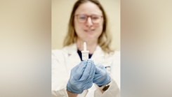 A researcher with Naval Medical Research Command's (NMRC) Clinical Trials Center (CTC) hold a self-administered nasal spray called INNA-051