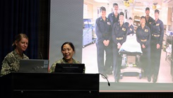 Lt. Cmdr. Kristine Tolentino Parra, right, and Lt. Stephanie Ryan, left, explain how the Expeditionary Medicine teams supported the historic Artemis II space recovery operations