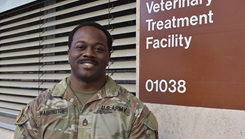 Staff Sgt. Dean Washington in front of a Veterinary Treatment Facility