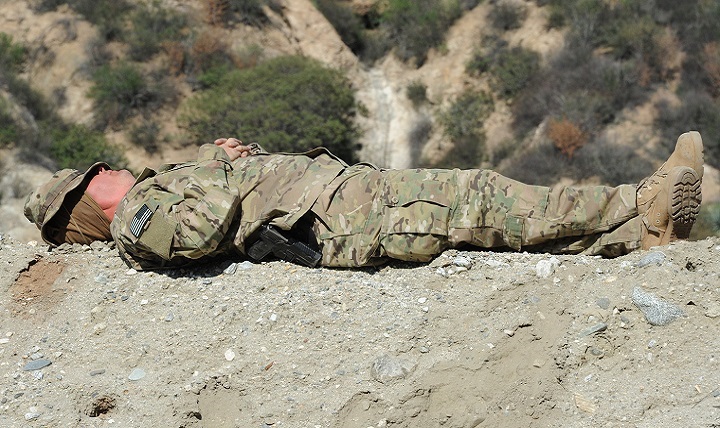 Navy Chief Mass Communication Specialist Keith DeVinney takes a long-needed break and sleeps on a bur during a field training exercise in the Angeles National Forest near Azusa, California.