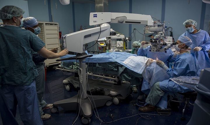Navy surgeons aboard the hospital ship USNS Mercy perform cataract surgery on a patient during Pacific Partnership 2015. 