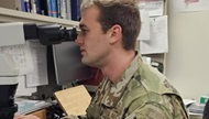 Intern looks in a microscope. 