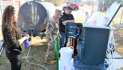 Tiffany Wise and Dr. Robert Gaeta, chief of nephrology at Womack Army Medical Center, ensure that equipment is set up properly while testing to see if dialysis can be successful in an austere environment