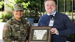 Col. Sheyla Baez Ramirez, commander of U.S. Army Garrison-Fort McCoy, visits Tomah Health in Tomah, Wis., on June 22, 2026, to present Tomah Health Chief Executive Officer Derek Daly and members of the hospital staff with a Fort McCoy Garrison Certificate of Appreciation