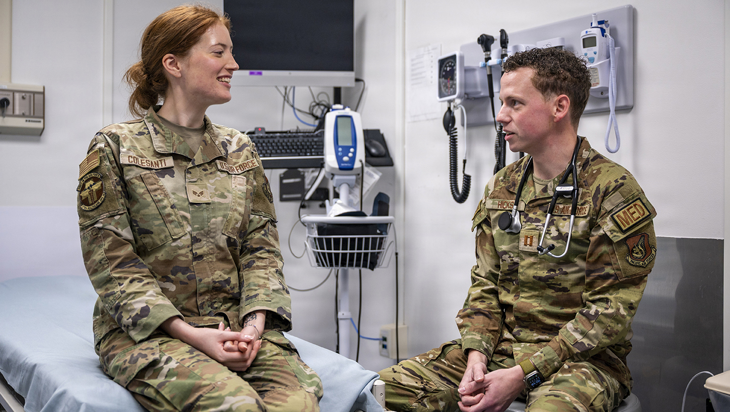 U.S. Air Force Capt. Zachary Hicks, 374th Health Care Operations Squadron family medicine physician, simulates a patient screening with Senior Airman Sofia Colesanti, 374th Health Care Operations during a patient visit 