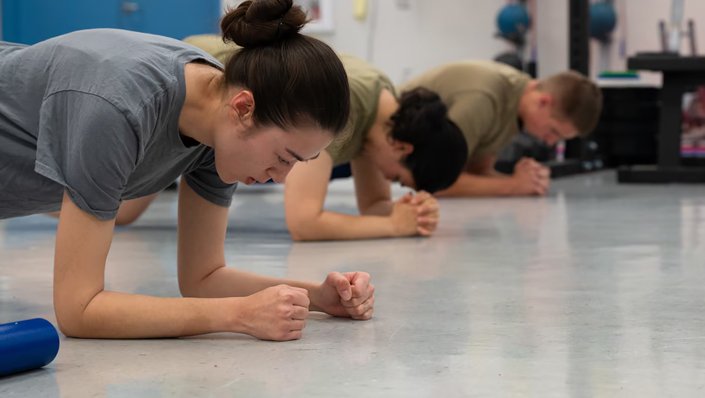 U.S. Air Force Airman 1st Class Tatyana Khitlik, left, Airman 1st Class Marcia Dubon, center, and Airman 1st Class Evan Studley, all 62d Maintenance Squadron avionics technicians, perform group training exercises