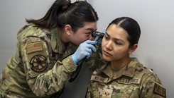 U.S. Air Force Senior Airman Yena Jung, left, occupational health technician with Bolling Medical Squadron Public Health, performs an ear inspection on Senior Airman Enmy Molina Martinez