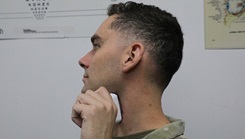 A Service Member demonstrates a handheld device for electrically stimulating the vagus nerve