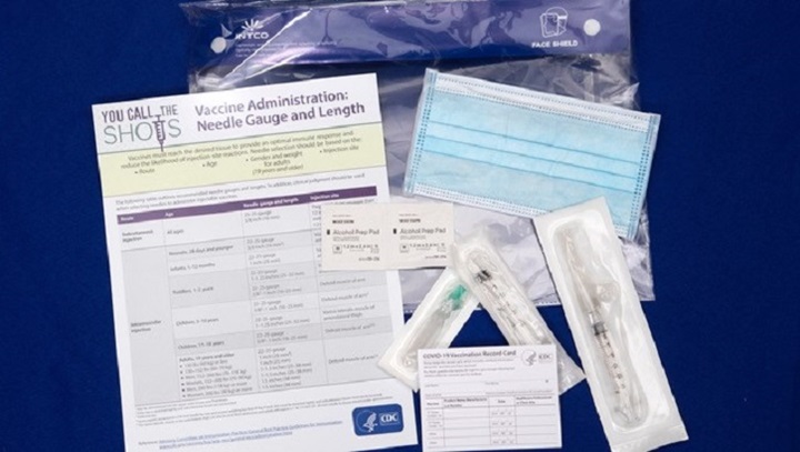 Image of Image with documents and vaccine products laying on table.
