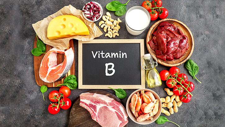 Image of A colorful board of foods with vitamin B including grains, vegetables,, and meats.