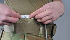 An Airman of the 185th Air Refueling Wing measures his waist