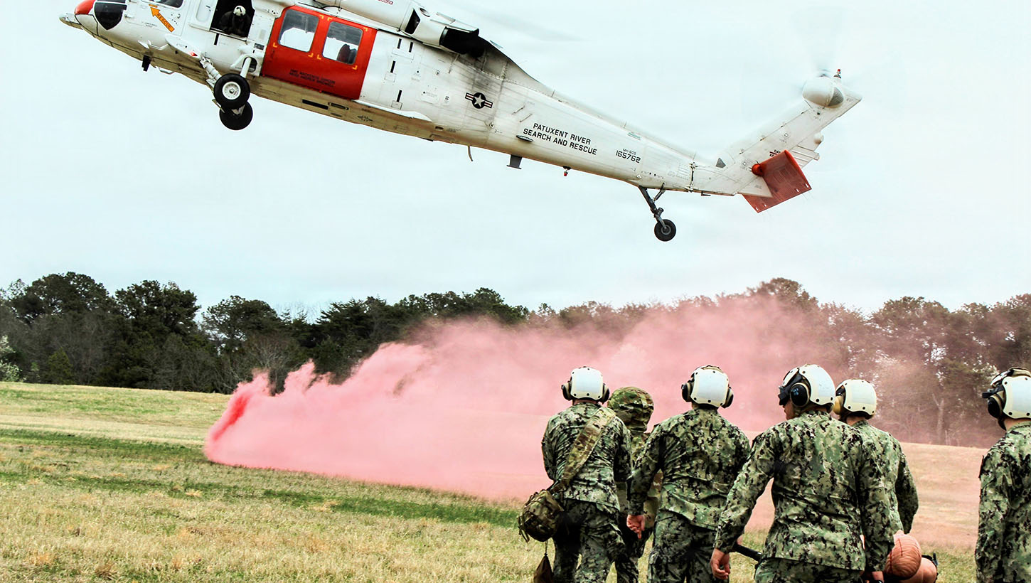 U.S. Navy Hospital Corpsman assigned to Navy Medicine Readiness and Training Command (NMRTC) Patuxent River transport a simulated casualty on a litter toward an MH-60S Sea Hawk helicopter