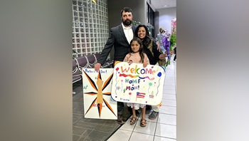 Air Force Capt. (Dr.) Laura Barrera is greeted by her husband, John Maurice, and daughter after returning from deployment. 