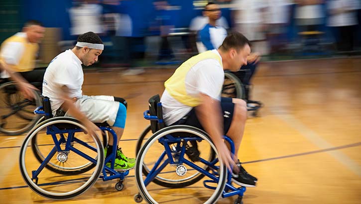 Airmen race for a loose ball during an Air Force Wounded Warrior basketball game 
