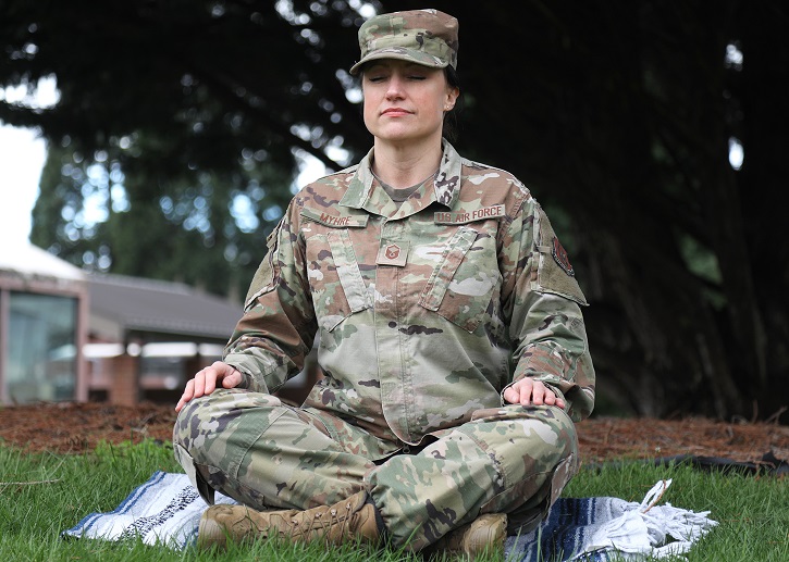 U.S. Air Force Master Sgt. Kathleen A. Myhre, 446th Airman and Family Readiness Center noncommissioned officer in charge, meditates outside the 446th Airlift Wing Headquarters building on Joint Base Lewis-McChord, Washington, Feb. 12, 2020. Myhre traveled to India in 2016 to study to become an internationally-certified yoga instructor. She now shares her holistic training with Reserve Citizen Airmen of the 446th AW. (U.S. Air Force photo by Staff Sgt. Mary A. Andom)