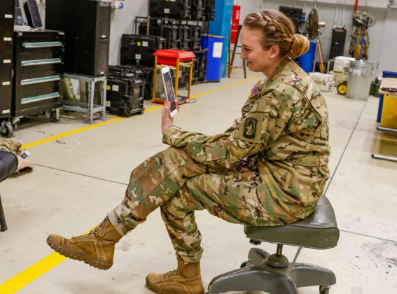 Army woman holding phone